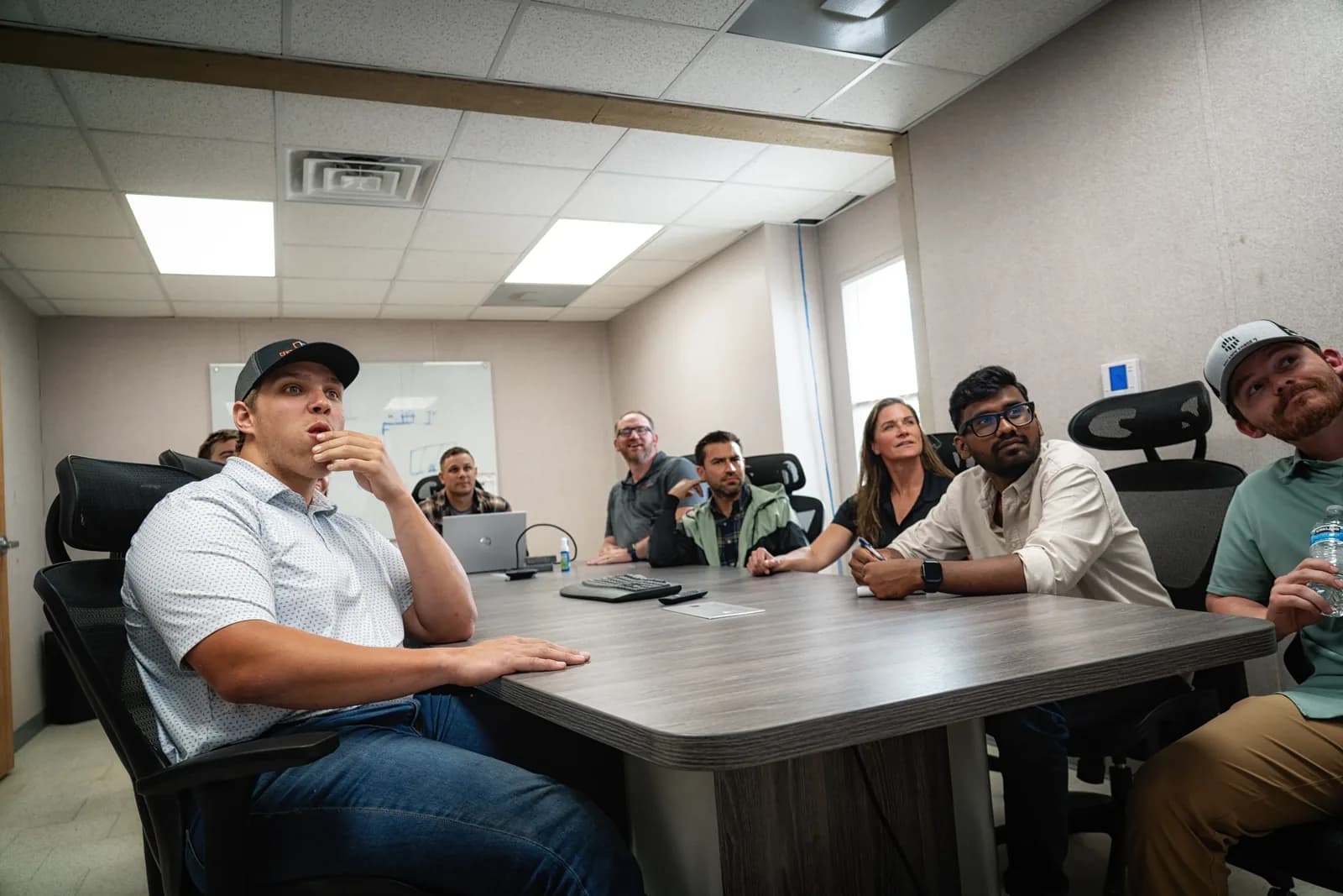Century Builders crew and staff meeting around a conference table on site