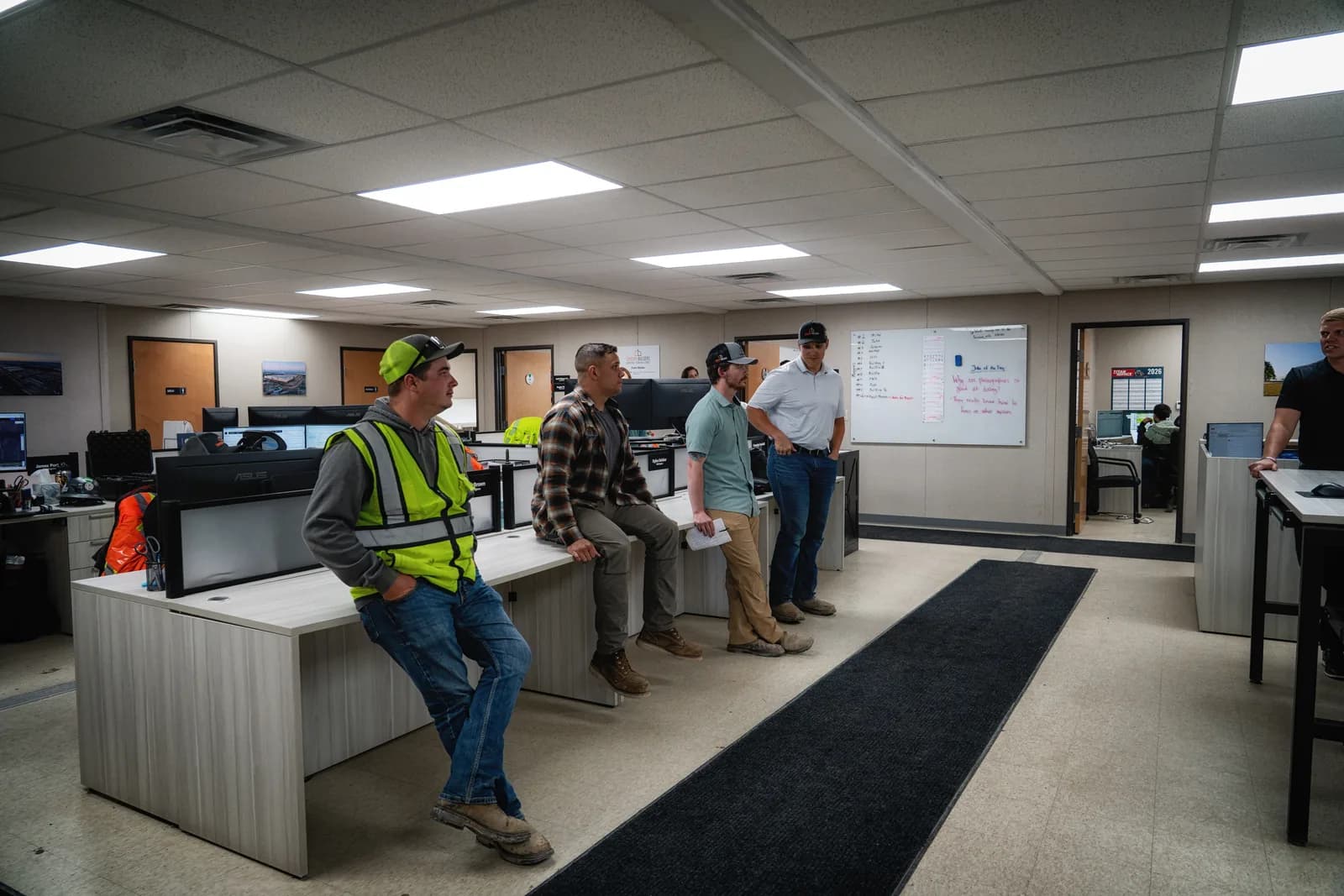 Century Builders team members talking together in the field-office bullpen