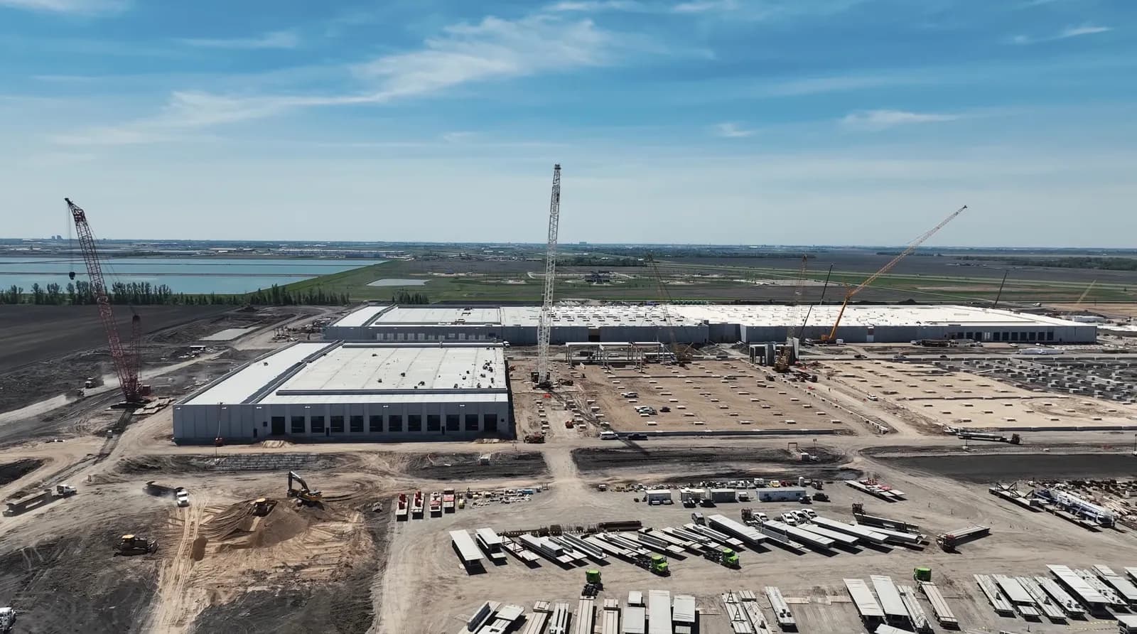Drone view of a large data center construction site with cranes and tilt-up buildings